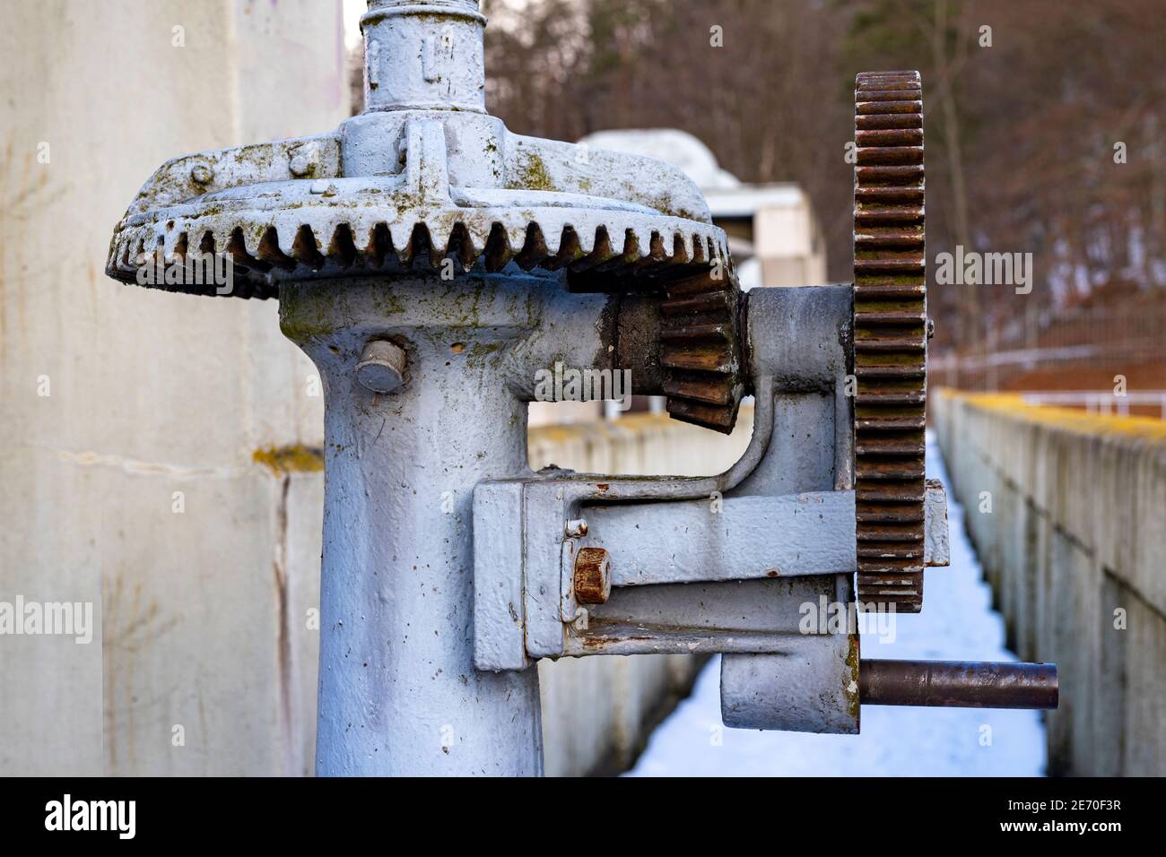 Large gears in an old gearbox. Steel structure to transfer rotational energy. Light background. Stock Photo