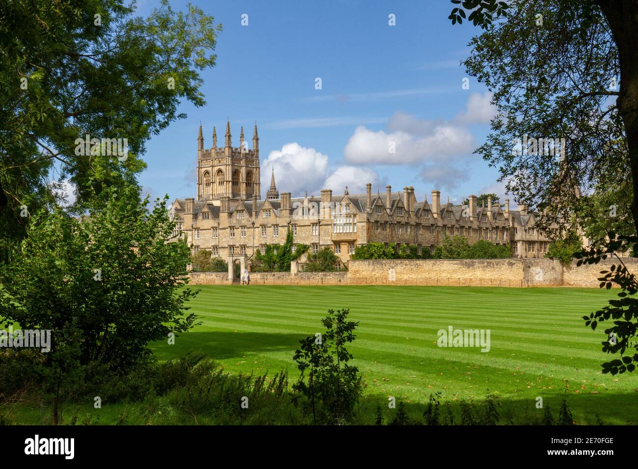 Merton College of the University of Oxford viewed across Merton Field, Oxford, Oxfordshire, UK.  The path directly under the wall is called Deadman's Stock Photo