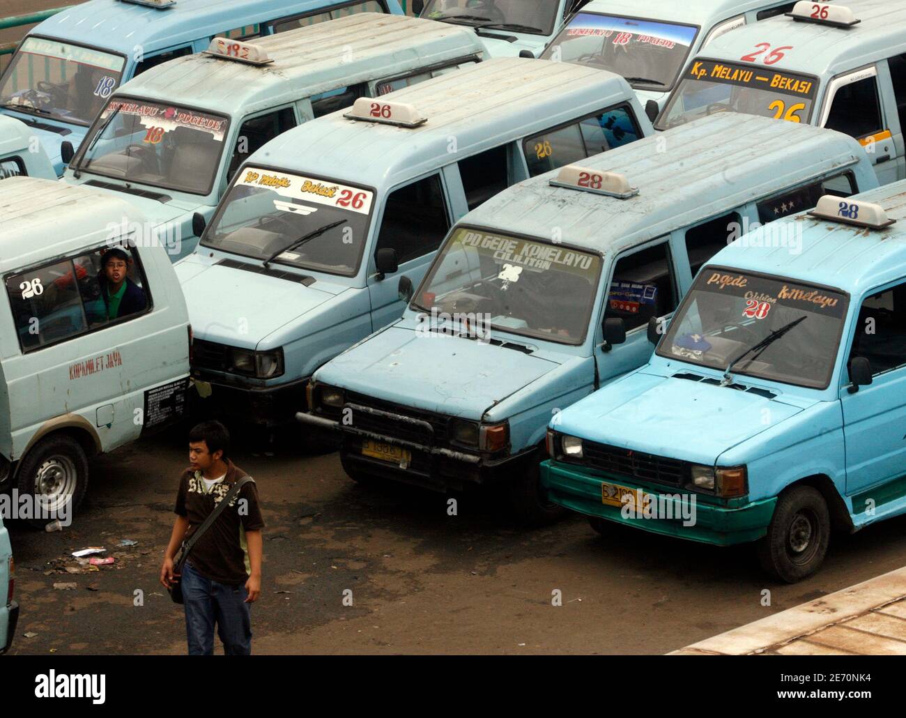 The 1990s model of the Toyota Kijang used for public transportation is parked along a Jakarta street as it waits for passengers November 16, 2007. The Kijang, which mean 'deer' in Bahasa Indonesia, was first launched in Indonesia in 1977, as cheap-- and not so attractive-- pick-up truck that could easily navigate the country's bumpy and often packed roads.  REUTERS/Supri   (INDONESIA) Stock Photo