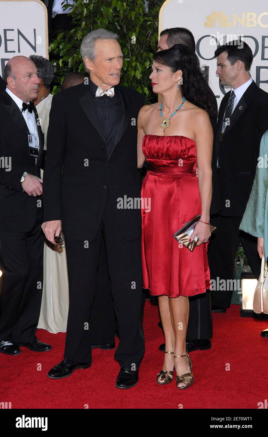 Clint Eastwood and Dina Ruiz pose on the red carpet of the 64th Annual