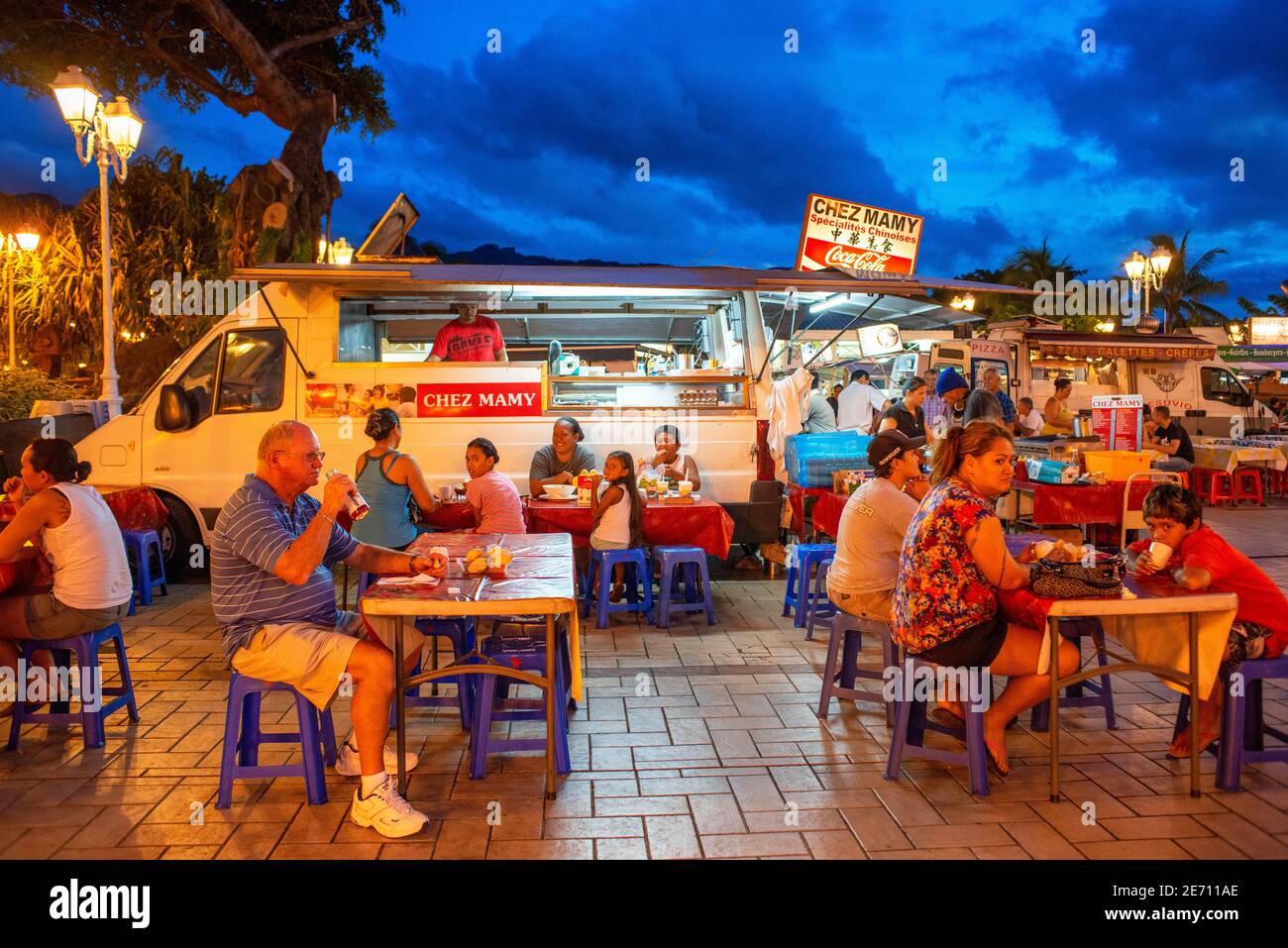 February 2020 - Outdoor dining in a plaza among roulotte food vans at  Papeete on the island of Tahiti, Tahiti Nui, Society Islands, French  Polynesia, South Pacific. Food inside a Les Roulottes