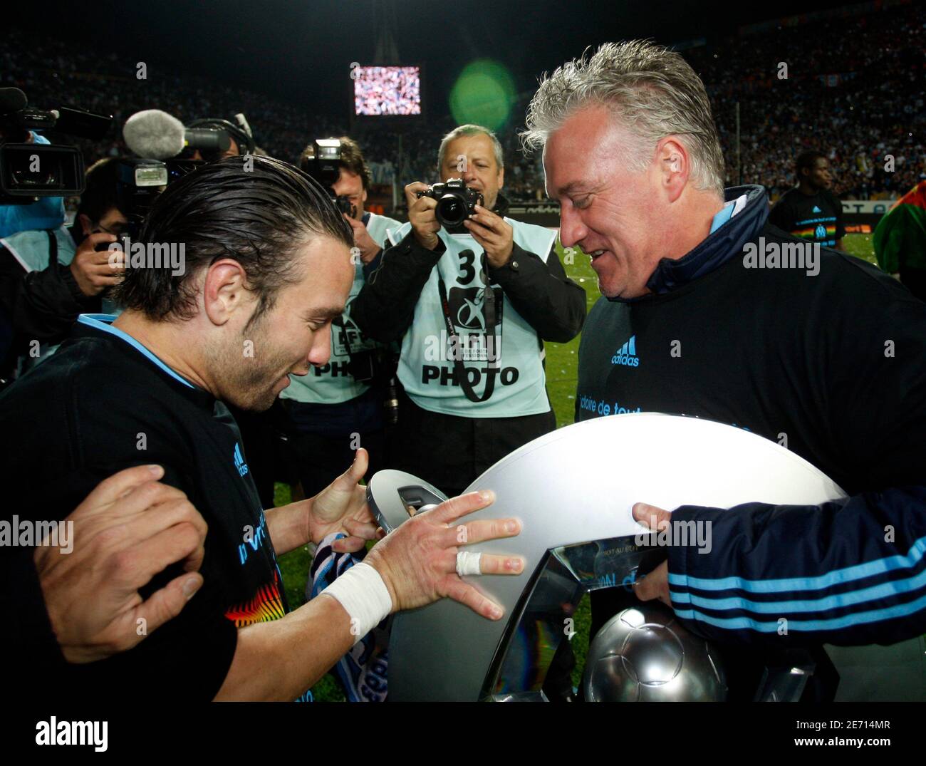 olympique-marseilles-coach-didier-deschamps-r-and-player-mathieu-valbuena-hold-up-the-french-championship-trophy-after-winning-their-ligue-1-title-at-the-velodrome-stadium-in-marseille-may15-2010-reutersphilippe-laurenson-france-tags-sport-soccer-2E714MR.jpg