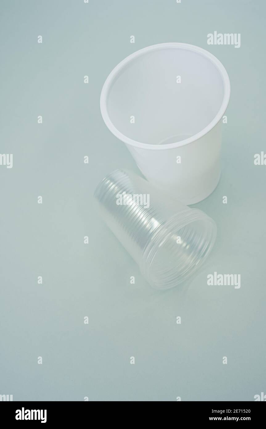Vertical shot of big and small plastic cups on a blue surface Stock ...