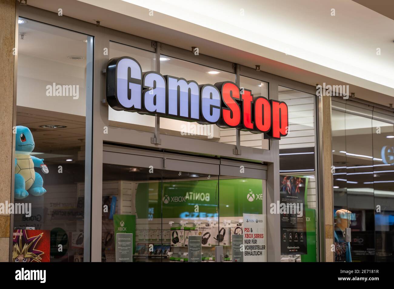 GameStop store front in a shopping center. Big illuminated logo shining during Covid-19 lockdown while the retail shop remains closed. Stock Photo