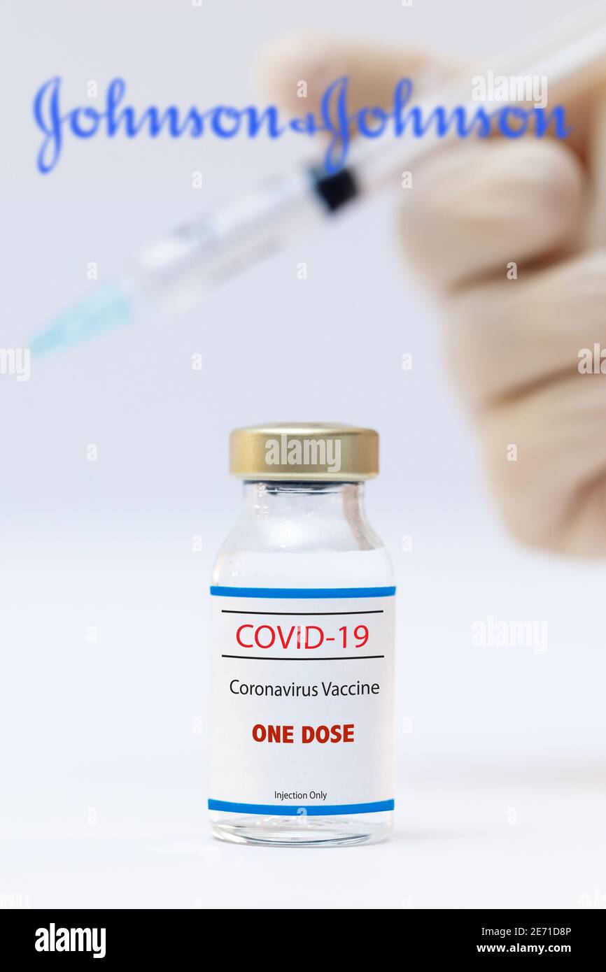 Bottle of a one dose coronavirus vaccine and jhonson and jhonson logo as background. Stock Photo