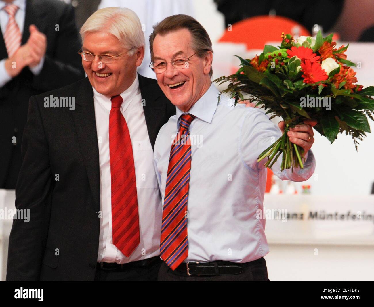 Franz Muentefering (R) waves flowers after he was elected as leader of Germany's Social Democratic party SPD at a one-day party congress in Berlin October 18, 2008, while he stands with Foreign Minister Frank-Walter Steinmeier. Germany's Social Democrats crowned Steinmeier as their candidate for chancellor and elected Muentefering as their leader on Saturday. REUTERS/Wolfgang Rattay (GERMANY) Stock Photo