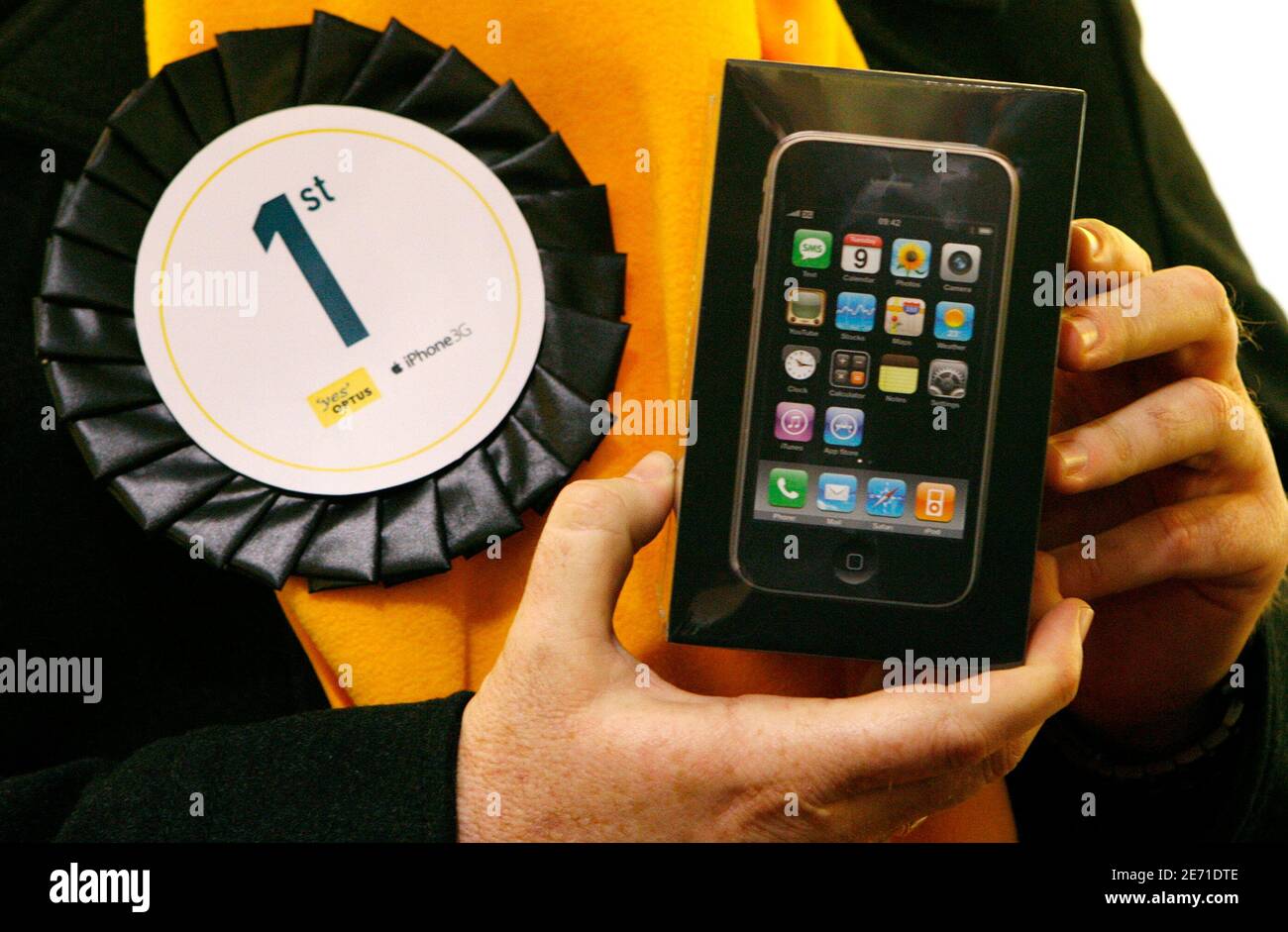 Brett Howell, the first Apple iPhone 3G buyer in Australia, poses with his  iPhone purchase after it goes on sale in a store in central Sydney July 11,  2008. The new iPhone