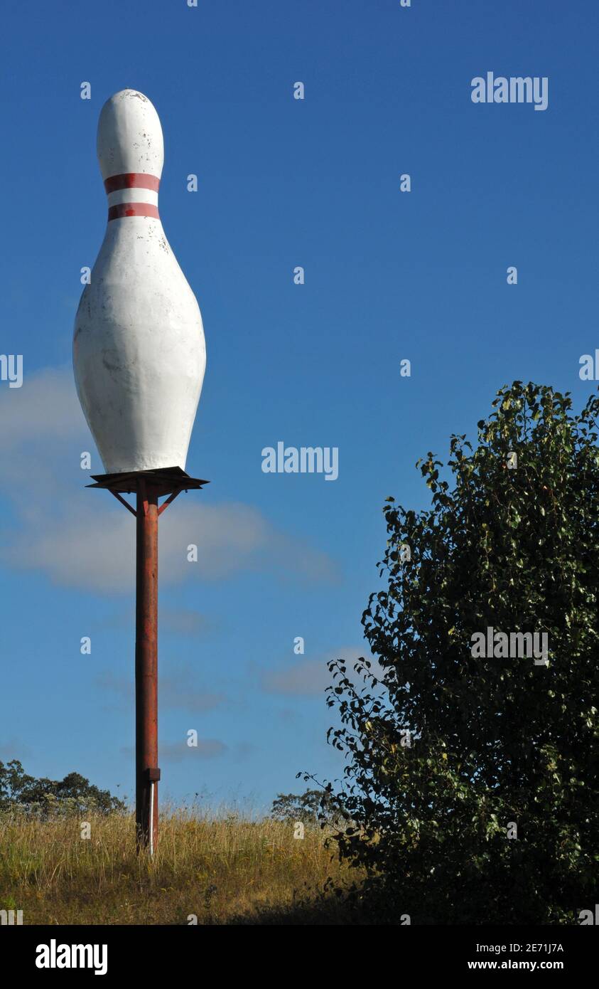 A giant bowling pin serves as a roadside advertisement for a now-closed bowling alley in Waynesville, Missouri. Stock Photo
