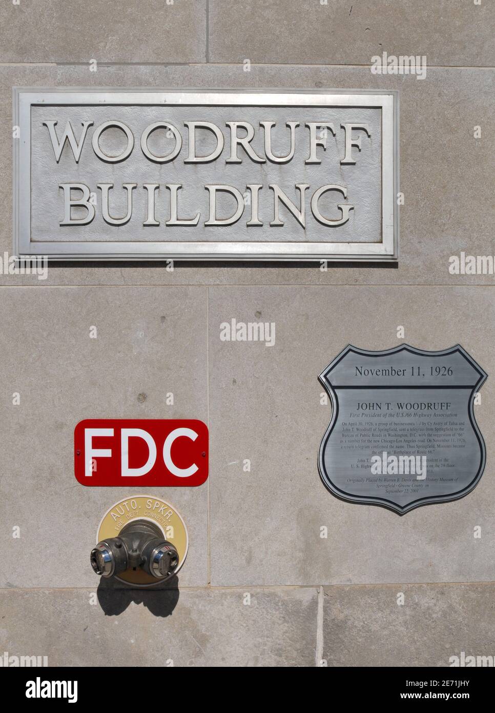 A heritage plaque adorns the historic Woodruff Building in downtown Springfield, noting builder John T. Woodruff's role in the creation of Route 66. Stock Photo