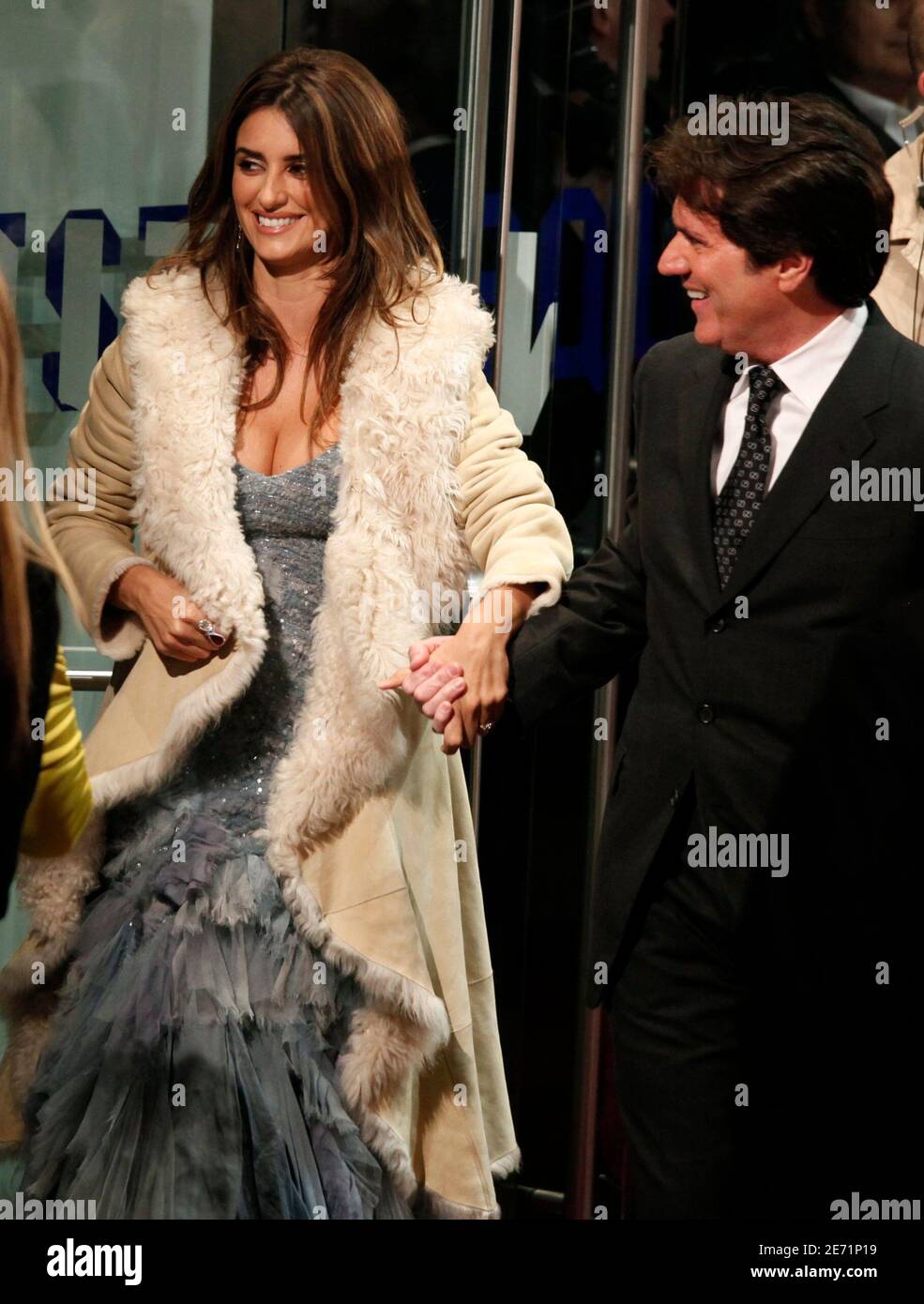 Spanish actress Penelope Cruz, wearing a Ralph Lauren Spring 2010  Collection gown and coat, smiles with film director Rob Marshall as they  arrive for the world premiere of their movie "Nine" at