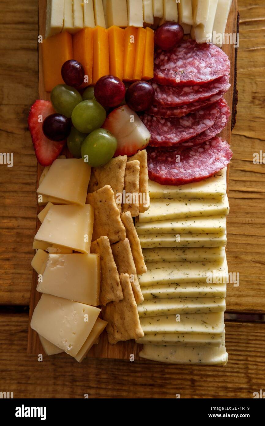 Italian charcuterie board featuring crackers cheese and salami served
