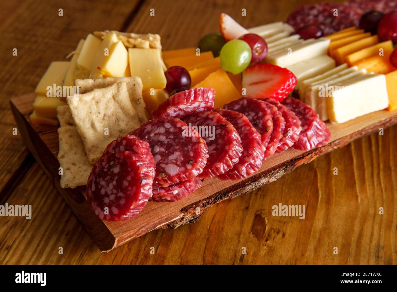 Italian charcuterie board featuring crackers cheese and salami served