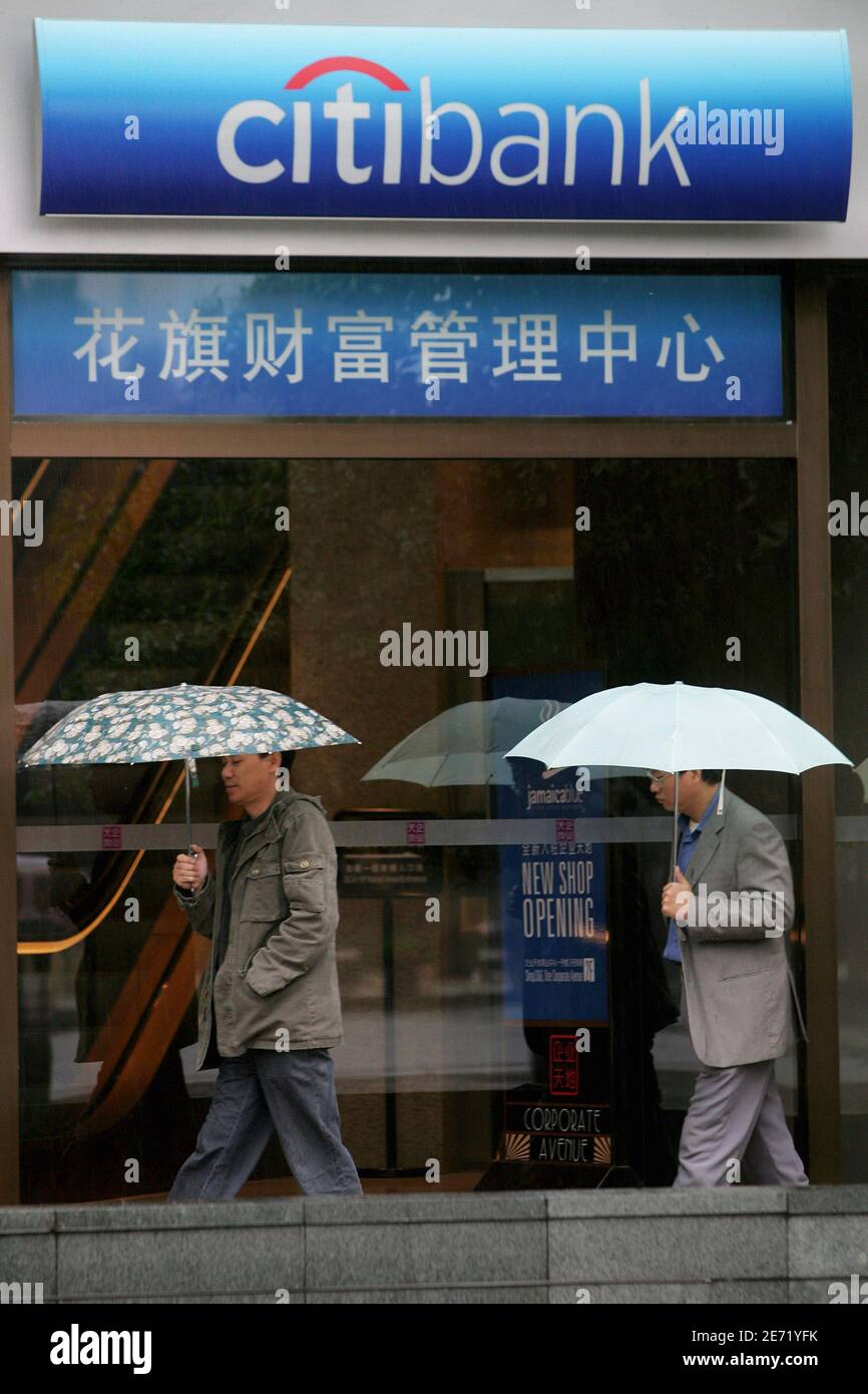 People walk past a Citibank branch in Shanghai November 16,2006. Citigroup Inc., was set to announce victory in a protracted $3 billion bid for a Chinese bank on Thursday, beating rival Societe Generale, two sources close to the deal said on Wednesday. Citigroup, the world's largest financial services provider, will take a 20-percent stake in southern China's Guangdong Development Bank, while International Business Machines Corp. will take about 5 percent, the sources said. REUTERS/Aly Song (CHINA) Stock Photo