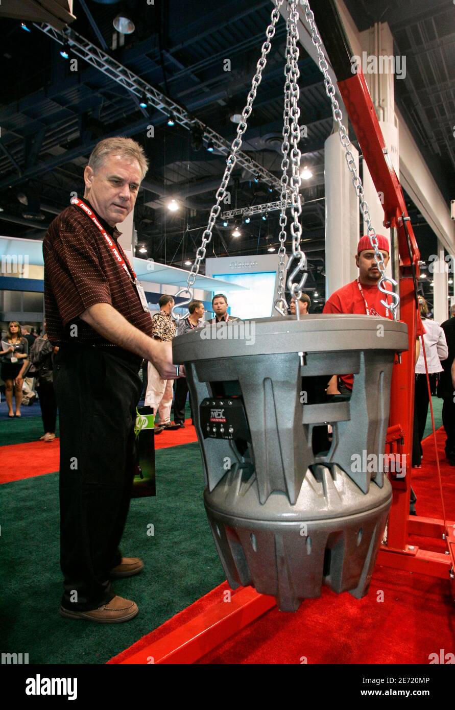 Ray Smith looks at the 'Jackhammer' subwoofer at the MTX Audio booth during the 2007 International International Consumer Electronics Show (CES) in Las Vegas, Nevada January 9, 2007. The 22-inch subwoofer wieghs 369 lbs. and can handle 12,000 watts of power, a representative said. The subwoofer is currentely available for $7,500, he said.  REUTERS/Steve Marcus (UNITED STATES) Stock Photo