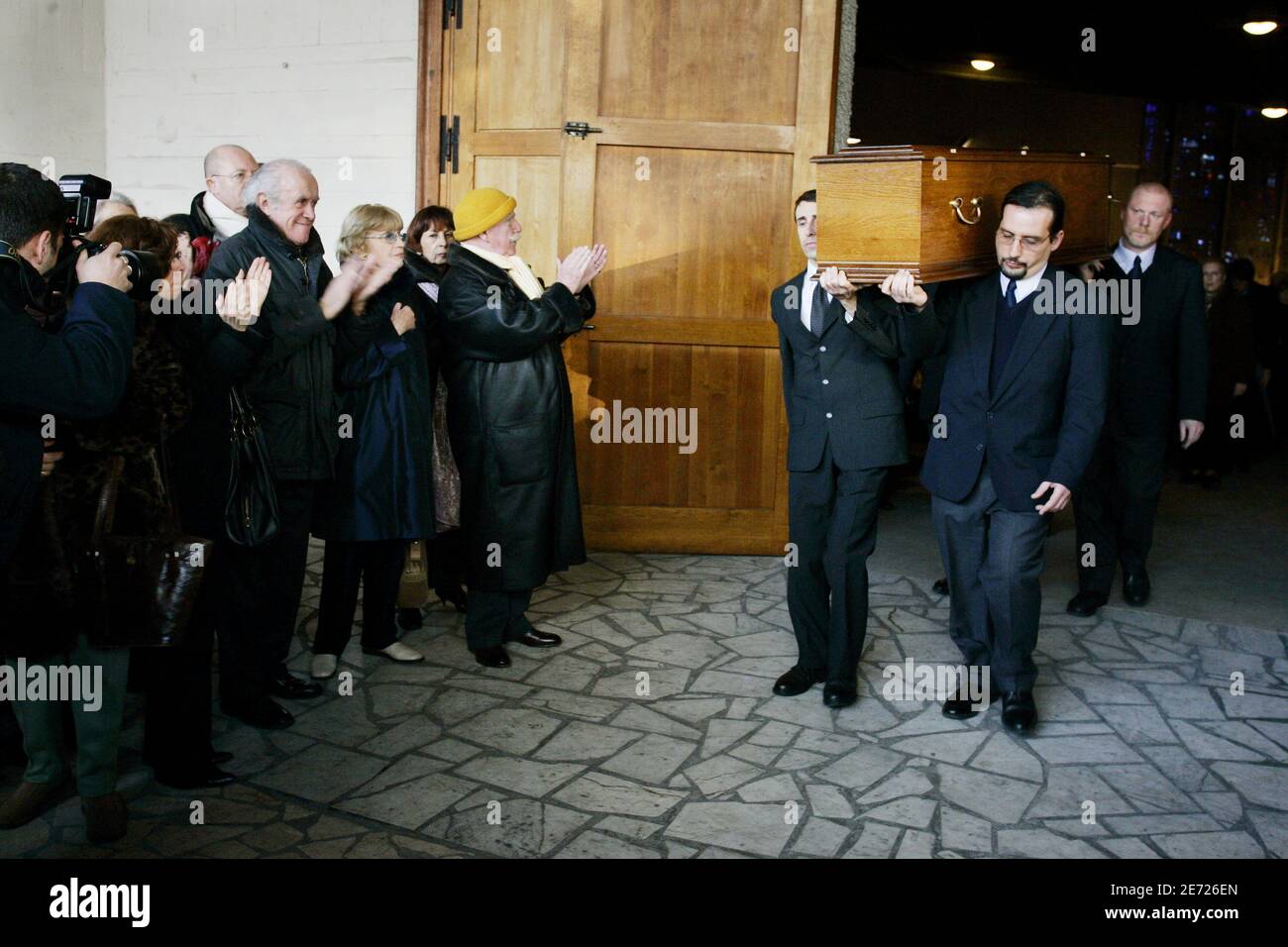 Jacques Balutin and Jean-Paul Rouland applause when the coffin of Michel Roux leaves the church of Colombes, suburb of Paris, France on February 8, 2007. Photo by Mousse/ABACAPRESS.COM Stock Photo