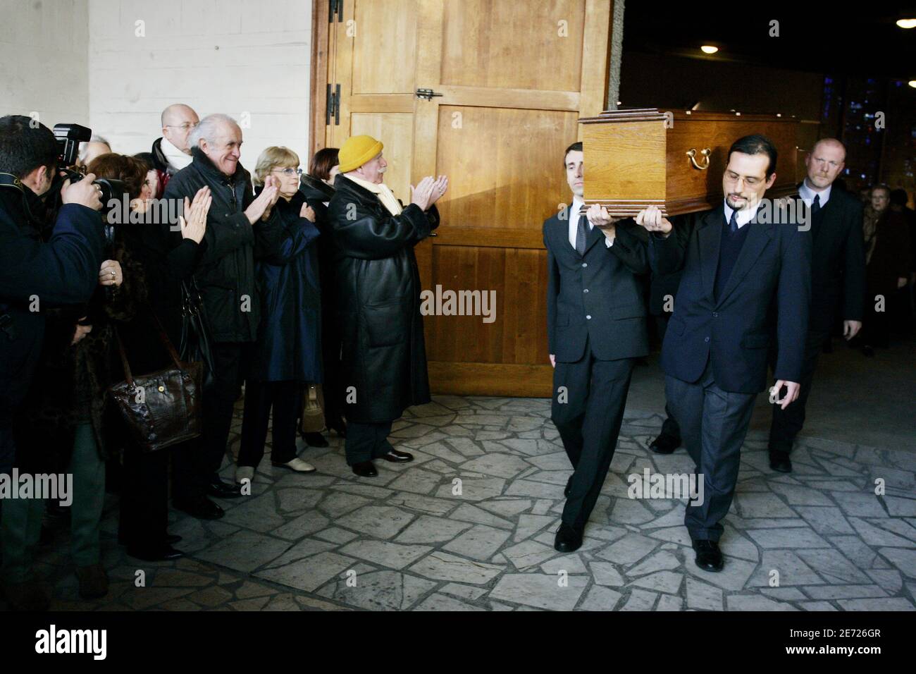 Jacques Balutin and Jean-Paul Rouland applause when the coffin of Michel Roux leaves the church of Colombes, suburb of Paris, France on February 8, 2007. Photo by Mousse/ABACAPRESS.COM Stock Photo