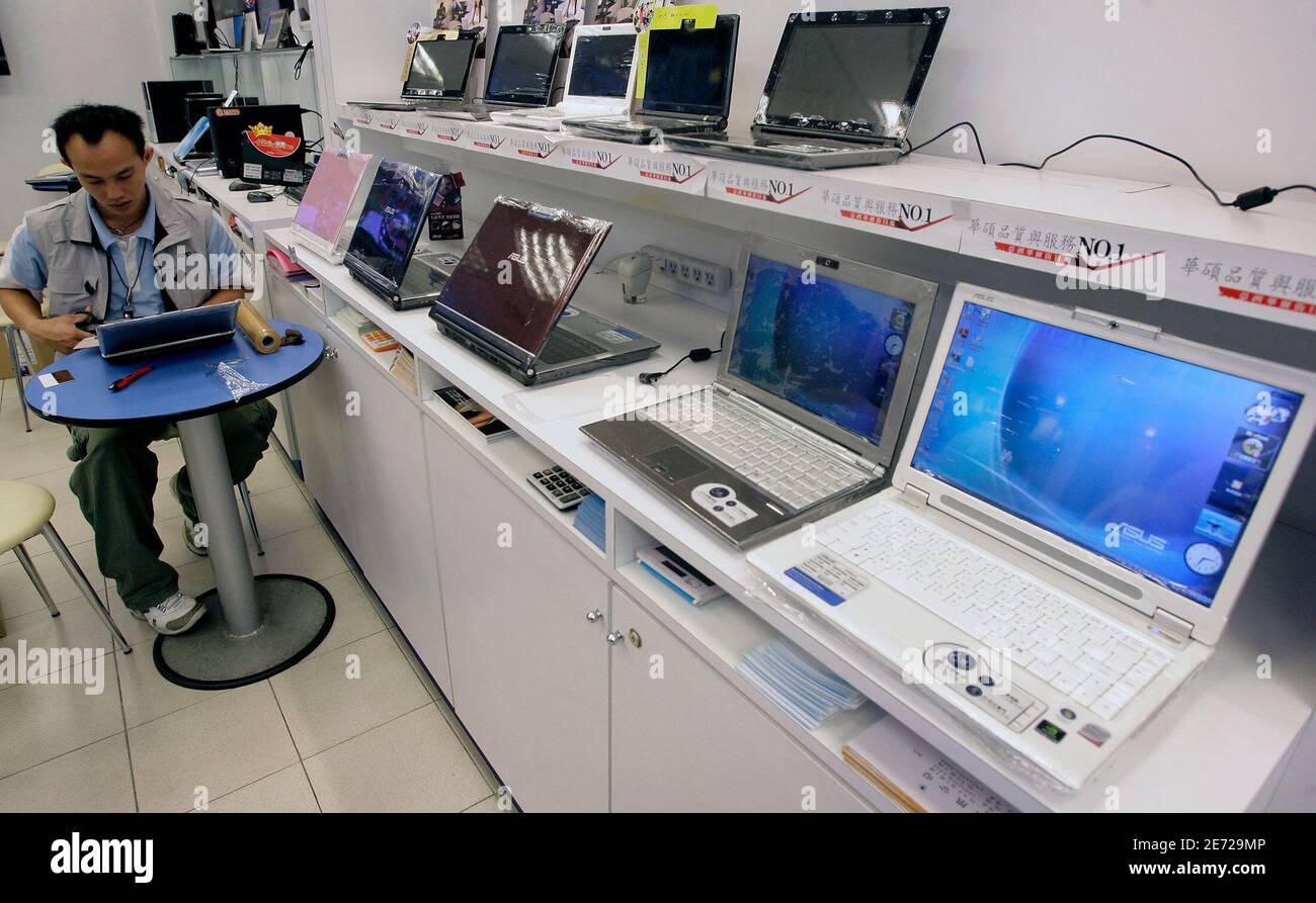 A shop attendant works on a laptop at a computer store in Taipei December  30, 2008. The age of the desktop PC appears to be over as its more portable  cousin, the
