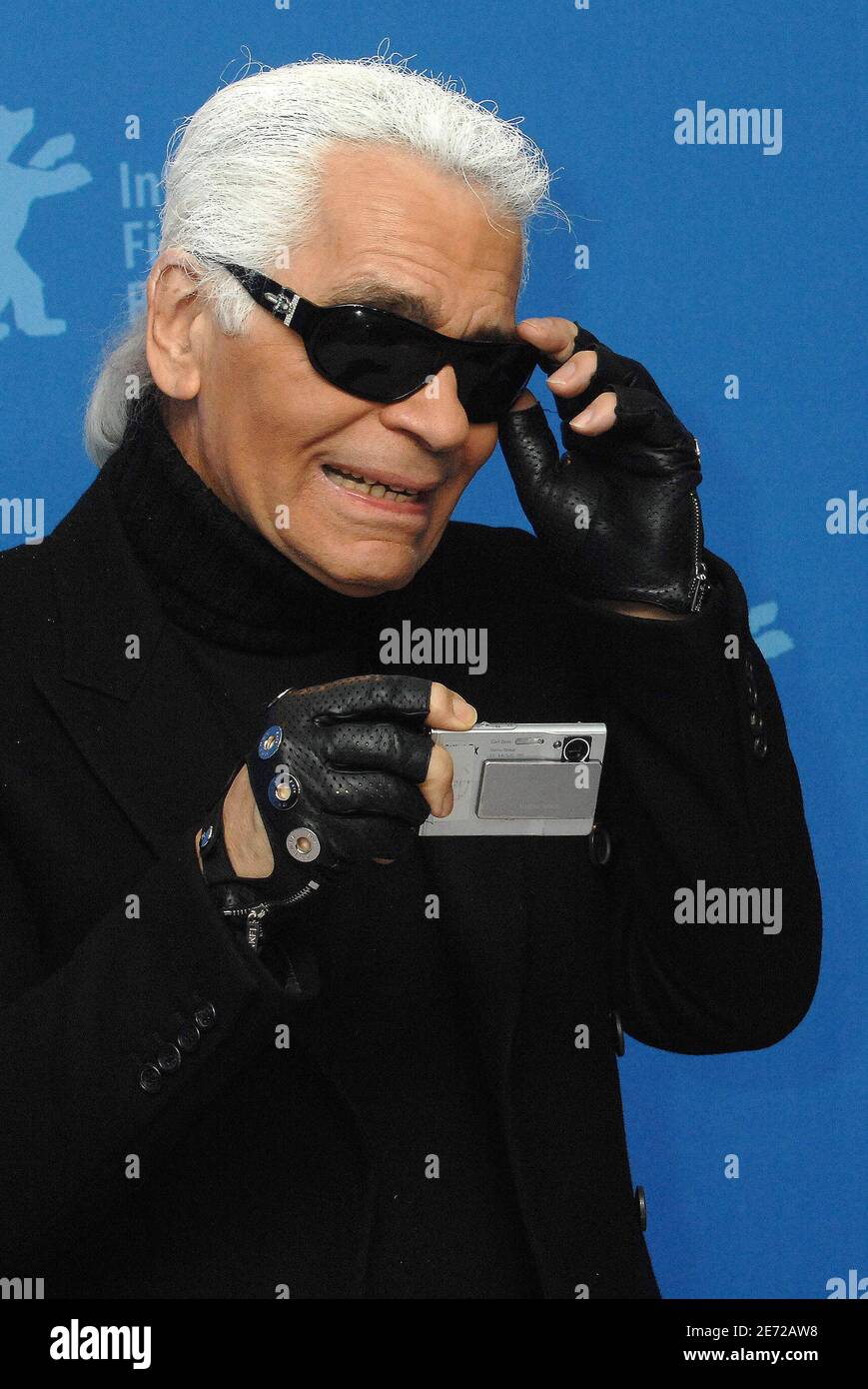 German Designer, Photographer and Director Karl Lagerfeld poses for  photographers and takes pictures of them during a photo-call for the movie 'Lagerfeld  Confidential' at the 57th International Film Festival Berlinale in Berlin,