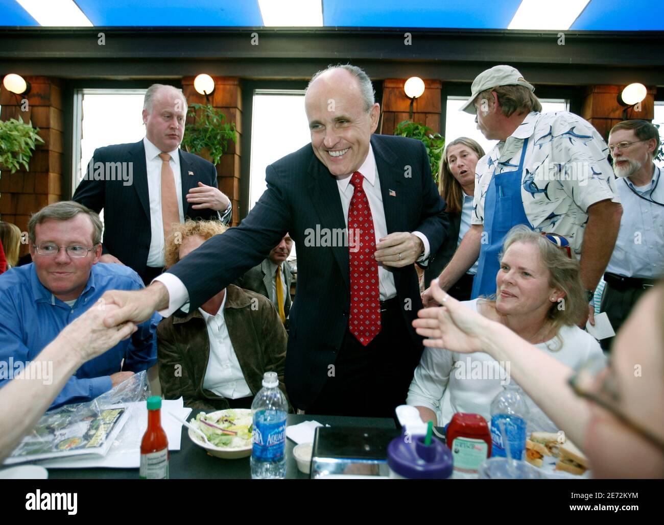 Former New York Mayor Rudy Giuliani greets people enjoying lunch at Point Loma Seafoods during a vist to San Diego, California  as part of his Presidential Exploratory Committee March 6, 2007.  REUTERS/Mike Blake (UNITED STATES) Stock Photo