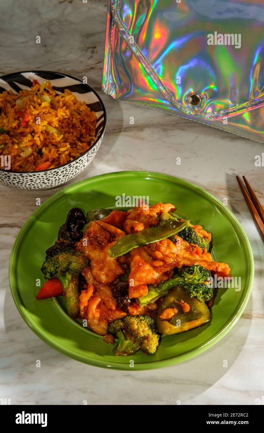 Chinese garlic chicken with sauteed mixed vegetables and side of pork fried rice Stock Photo