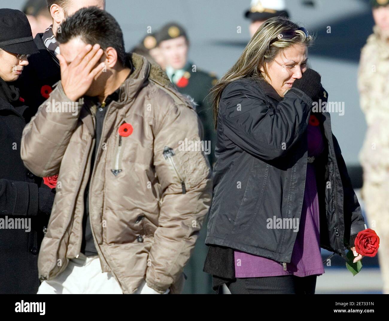 Darlene Thomas (R), the sister of Sapper Steven Marshall, grieves after  placing flowers on his casket at the Canadian Forces Base Trenton, November  3, 2009. Sapper Marshall was killed October 30, 2009