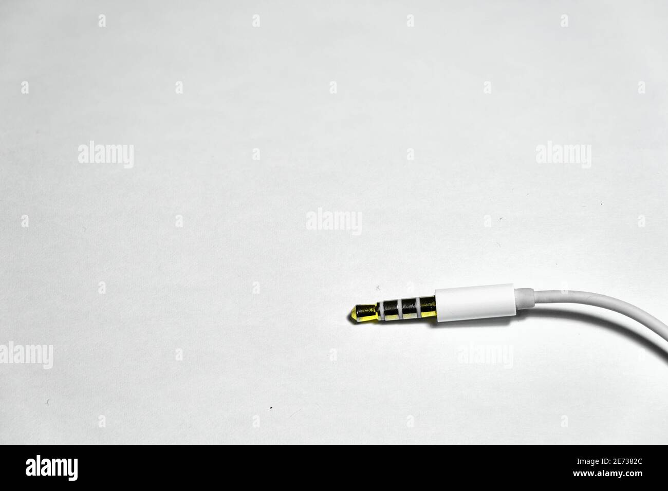 Electronic female socket of earpiece for phone connection with white isolated background and its shiny yellow brass Stock Photo