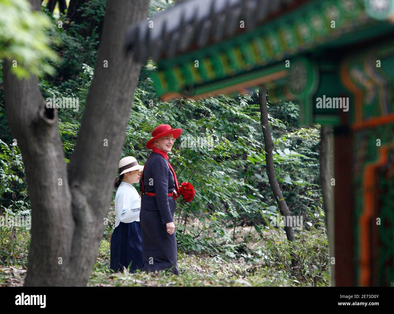 Denmark's Queen Margrethe II (R) visits the Biwon garden in the Changdeokgung palace in Seoul as a guide briefs her October 10, 2007. REUTERS/Lee Jae-Won (SOUTH KOREA) Stock Photo