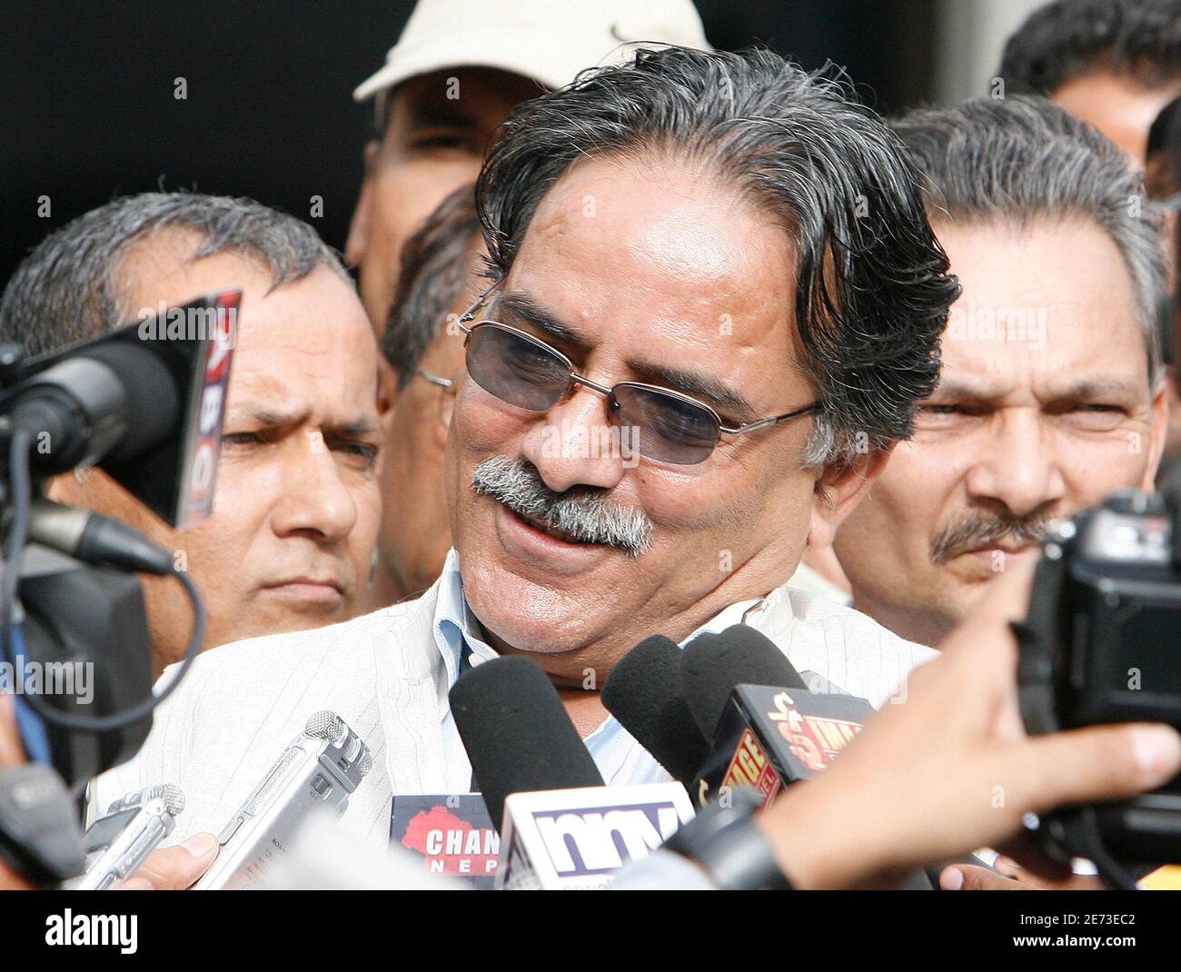 Maoist leader Prachanda (C) talks to the media after filing his nomination  for the post of Prime Minister, in Kathmandu August 14, 2008. A special  assembly in Nepal will elect a new