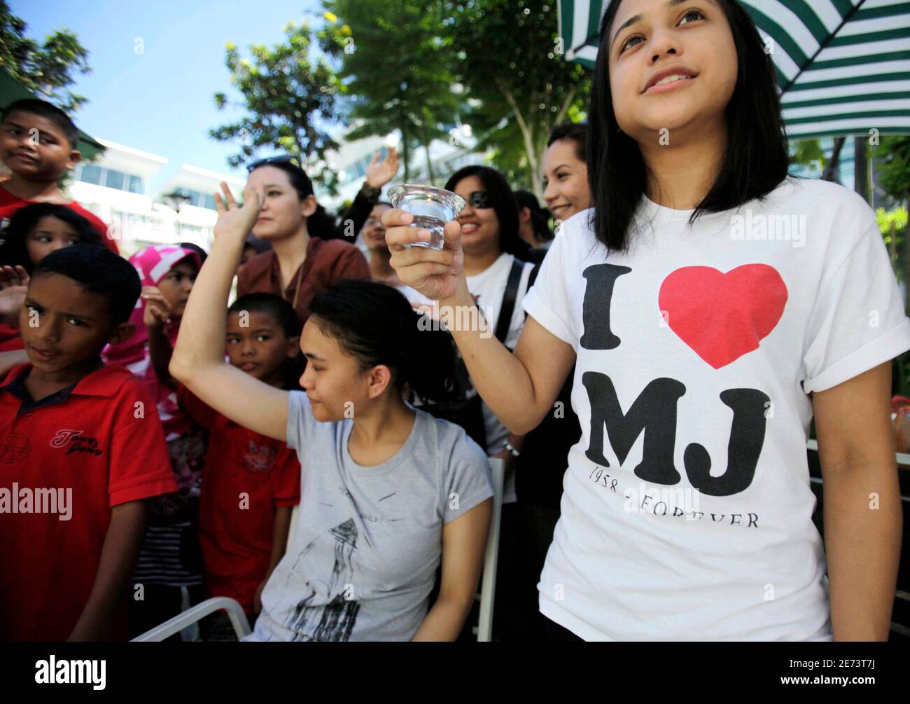 Michael Jackson Fans Hold Oil Lamps As They Sing A Song In Tribute To The Late Pop Icon In Shah Alam Outside Kuala Lumpur June 26 2010 Fans Worldwide Paid Tribute To