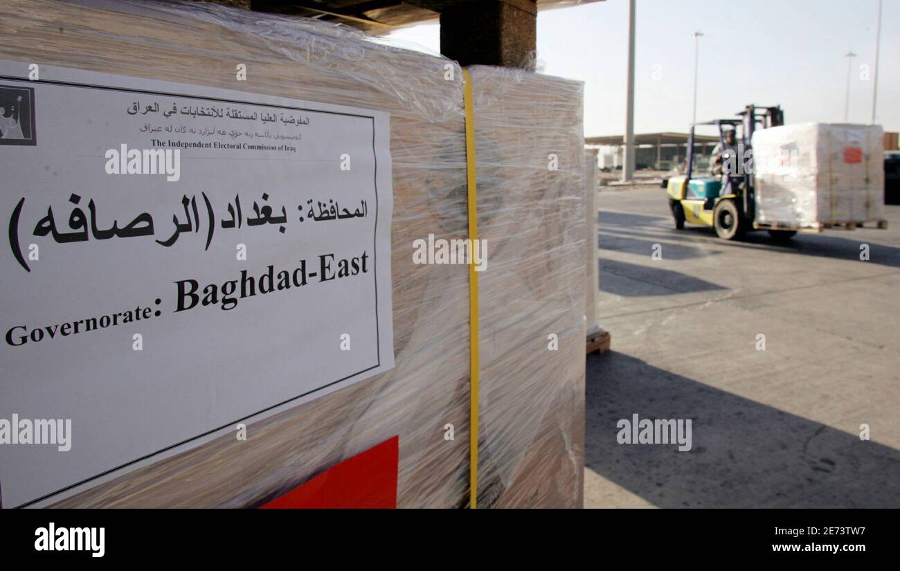 Ballots for the upcoming Iraqi parliamentary elections are unloaded at Baghdad International Airport December 3, 2005. [Iraq's most influential Shi'ite Muslim cleric, Grand Ayatollah Ali al-Sistani, has told believers to vote in elections on December 15 and urged them to support religious candidates, his office said on Saturday. The instructions from Sistani could dent the hopes of secular Shi'ite Iyad Allawi, a former prime minister whose non-sectarian party is mounting a strong challenge to the ruling Shi'ite Islamist coalition.  Picture taken December 3, 2005.] Stock Photo
