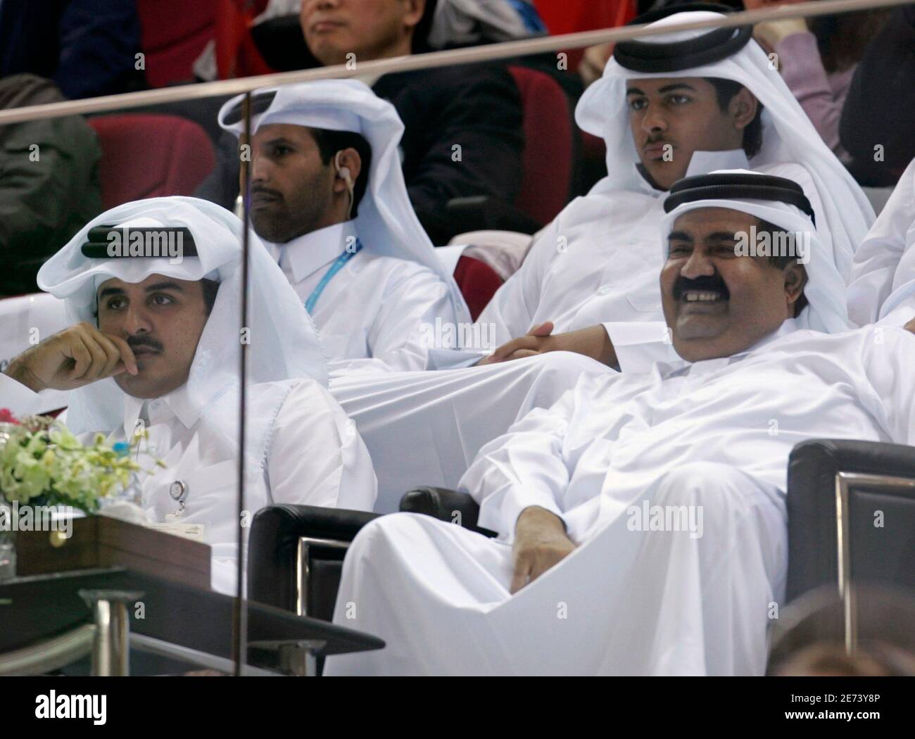 Qatar's Emir Sheikh Hamad Bin Khalifa Al-Thani (R) and Heir Apparent Sheikh Tamim  Bin Hamad Al-Thani (L) watch the men's gold medal basketball match between  China and Qatar at the 15th Asian