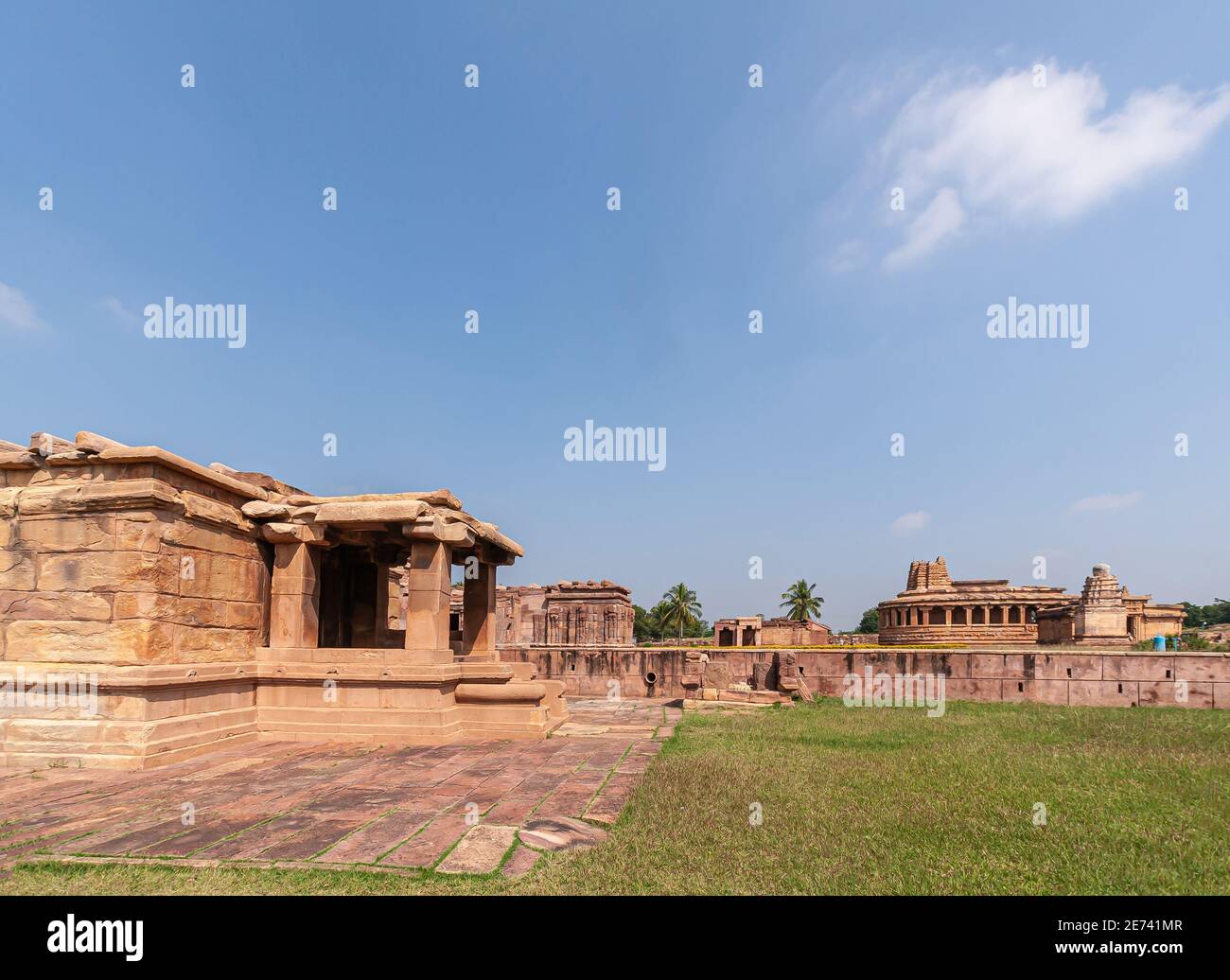 Aihole, Karnataka, India - November 7, 2013: Brown stone Lad Khan, Suryanarayana, an din the back Durga Gudi Temple landscape with green lawns under l Stock Photo