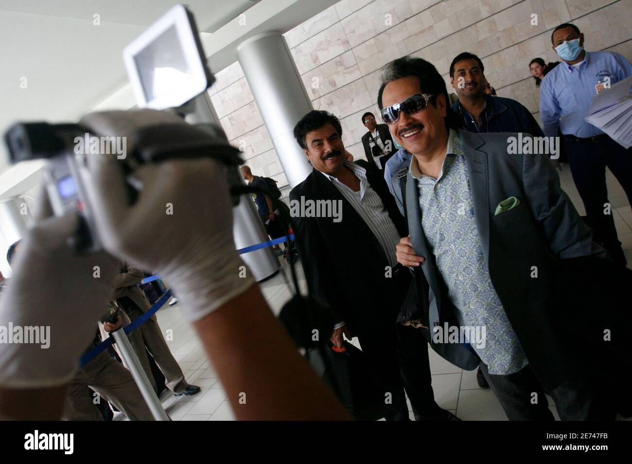 Mexican Hernan Hernandez, member of the 'Los Tigres del Norte' music group, is scanned for influenza A (H1N1), formerly referred to as swine flu, through a thermal camera to detect possible alterations in his body temperature upon his arrival at Toncontin airport in Tegucigalpa, April 30, 2009. The World Health Organisation (WHO), bowing to pressure from meat industry producers and concerned governments, said on Thursday it would refer to a deadly new virus strain as influenza A (H1N1), not swine flu.    REUTERS/Edgard Garrido   (HONDURAS HEALTH) Stock Photo