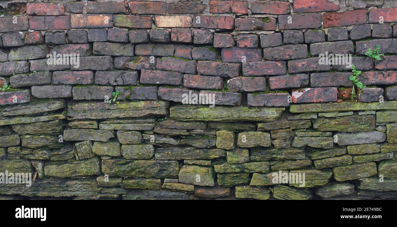 Old wall constructed with two types of bricks Stock Photo