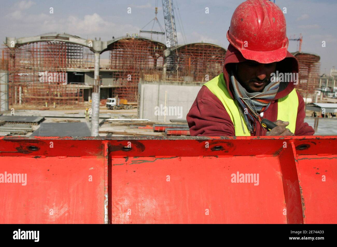 A construction worker stands at a new building site at Queen Alia Airport,  35 km (22 miles) south of Amman, February 9, 2010. Airport International  Group (AIG) recently announced that there has