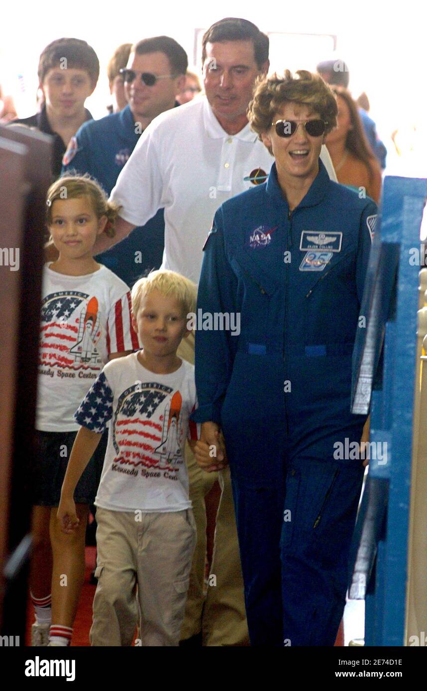 Shuttle Commander Eileen Collins (R), her husband Pat Youngs (C) and children Bridget (L), 9, and Luke, 4, arrive for a crew return celebration at the NASA hangar at Ellington Air Force base in Houston, Texas August 10, 2005. REUTERS/Tim Johnson  RJC/JJ Stock Photo