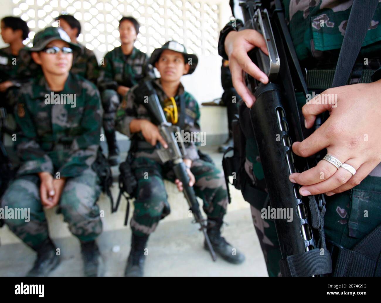 Policewomen wait to practice on the firing range during a Special