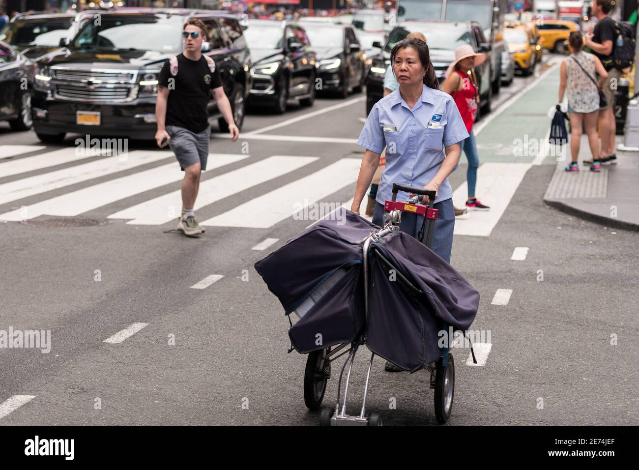 New York, USA. 22 Jun, 2019. A NYC USPS worker in a bike lane in Times