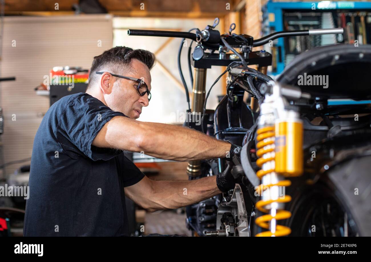 mechanic working on the repair of a motorcycle in the Stock Photo Alamy