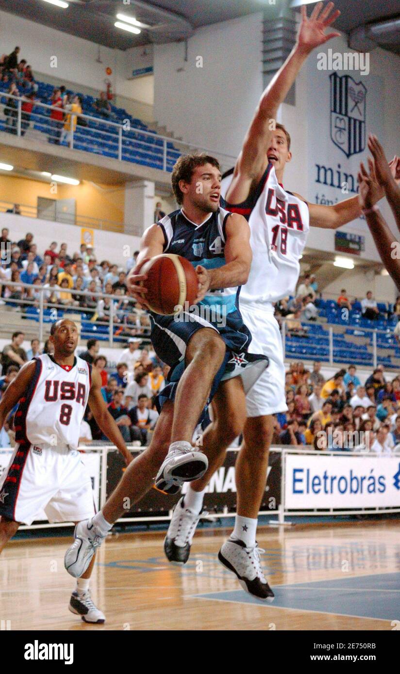 Argentina's Antonio Porta (C) goes for a layup between Marque Perry (L,  back) and Adam Chubb (R) of the U.S. during their basketball game on the  third day of the Eletrobras International