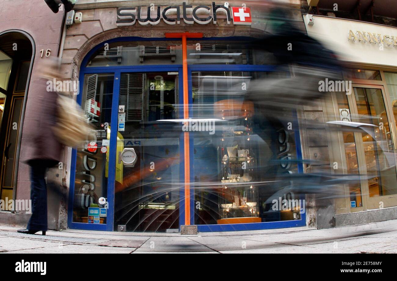 People walk past a Swatch watches shop in Strasbourg March 12, 2009. Swatch  Group, the world's largest watchmaker, said on Thursday it expects demand  to pick up in the second half of