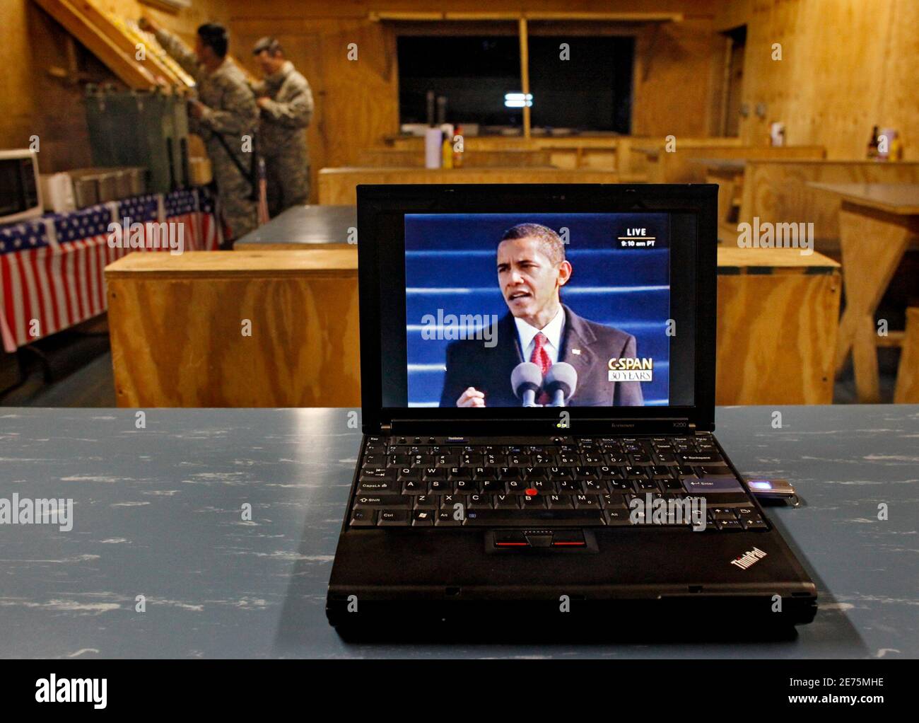 U.S. soldiers get food from the mess hall at Combat Outpost Keating in eastern Afghanistan as a webcast of President Barack Obama's  inaugural address is shown via webcast January 20, 2009.  REUTERS/Bob Strong  (AFGHANISTAN) Stock Photo