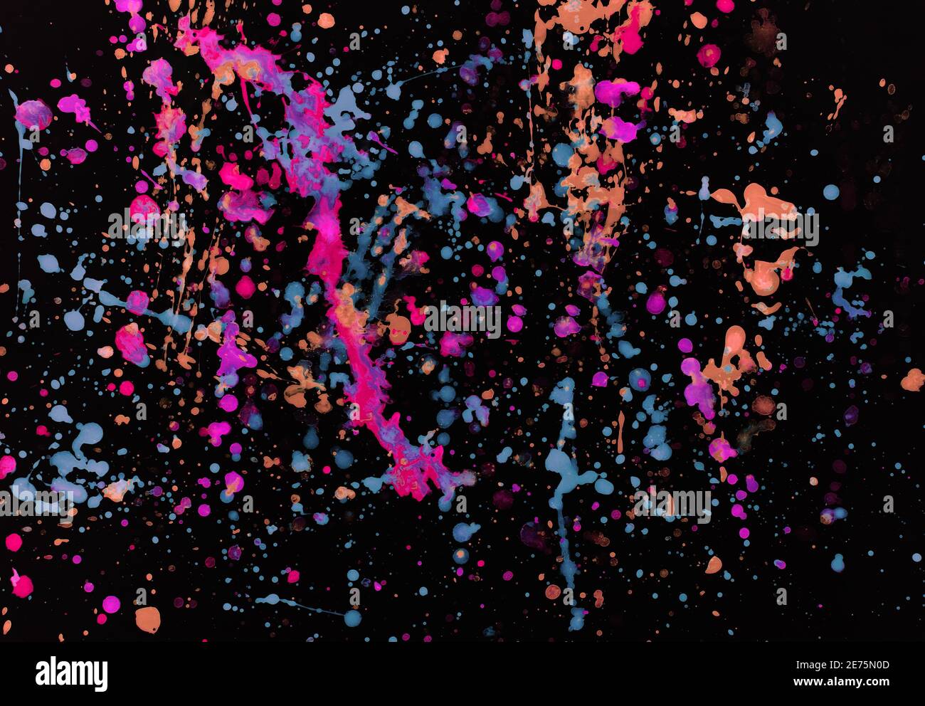 Speckled paint of different colors on a black background Stock Photo