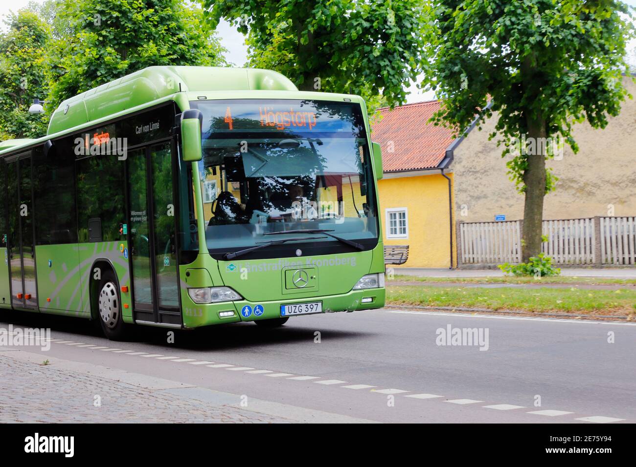 Vaxjo, Sweden June 26, 2018: Front view of green Mercedes-Benz city bus in service on line 4. Stock Photo