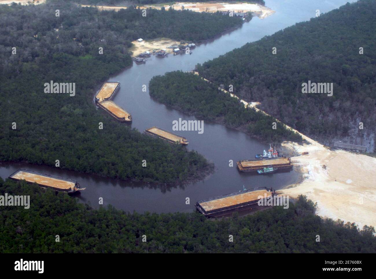 An aerial view shows barges lining up to wait to load sand, to be exported to Singapore, from a sand mine at Indonesia's Bintan island February 24, 2007. Indonesia has said it will stop the mining, which it blames for wiping out some of its islands off the map. The country has about 17,000 islands, but is not completely sure how many and has no official names for more than half. It plans to complete this year a survey to help manage them, particularly given concerns over rising sea levels due to climate change and sovereignty disputes.  To match feature INDONESIA ISLANDS. REUTERS/Yuli Seperi   Stock Photo