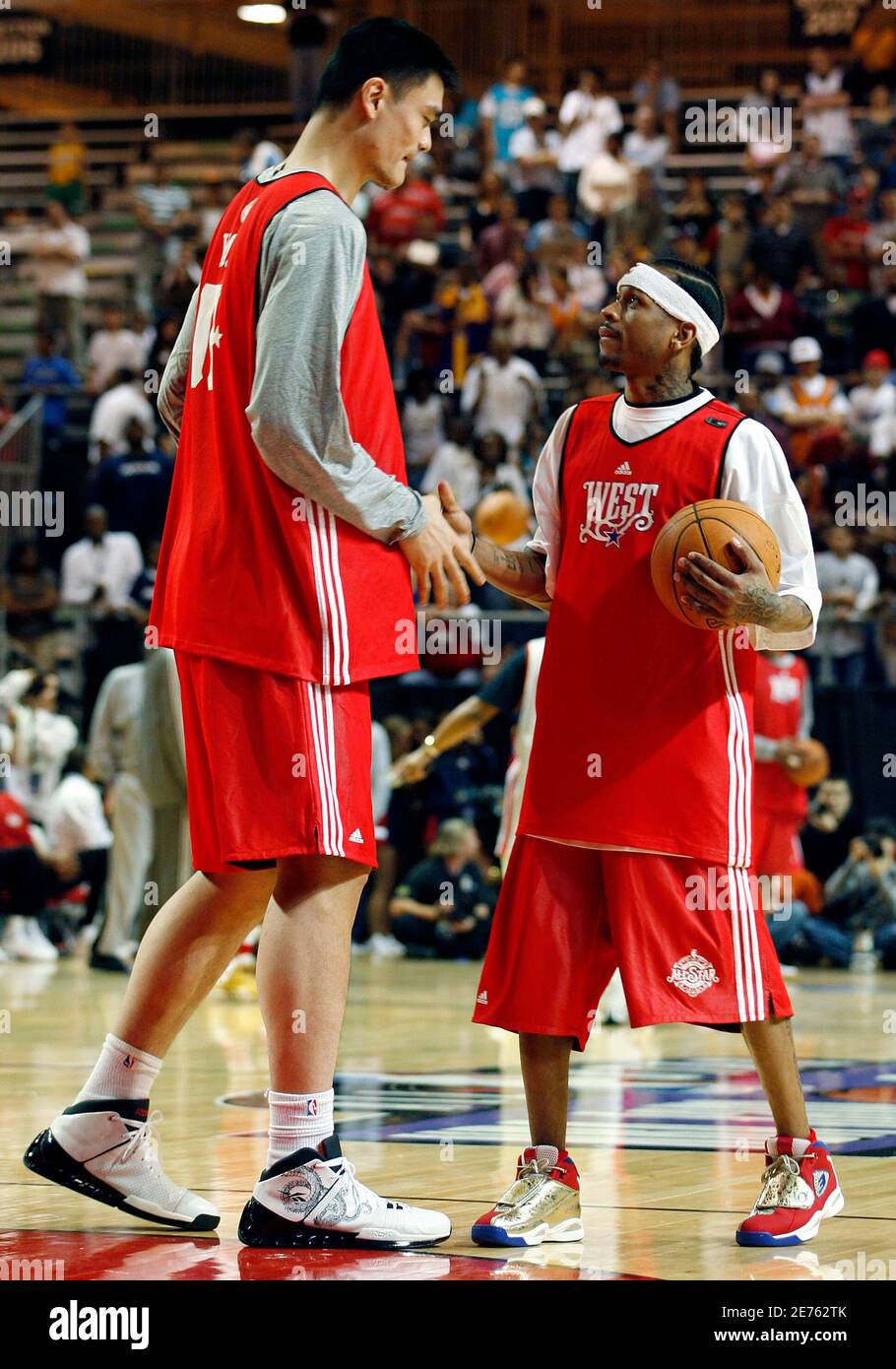 Houston Rockets center Yao Ming (L) of China shakes hands with Allen  Iverson of the Denver Nuggets during practice for the National Basketball  Association All-Star game in New Orleans, Louisiana February 16,