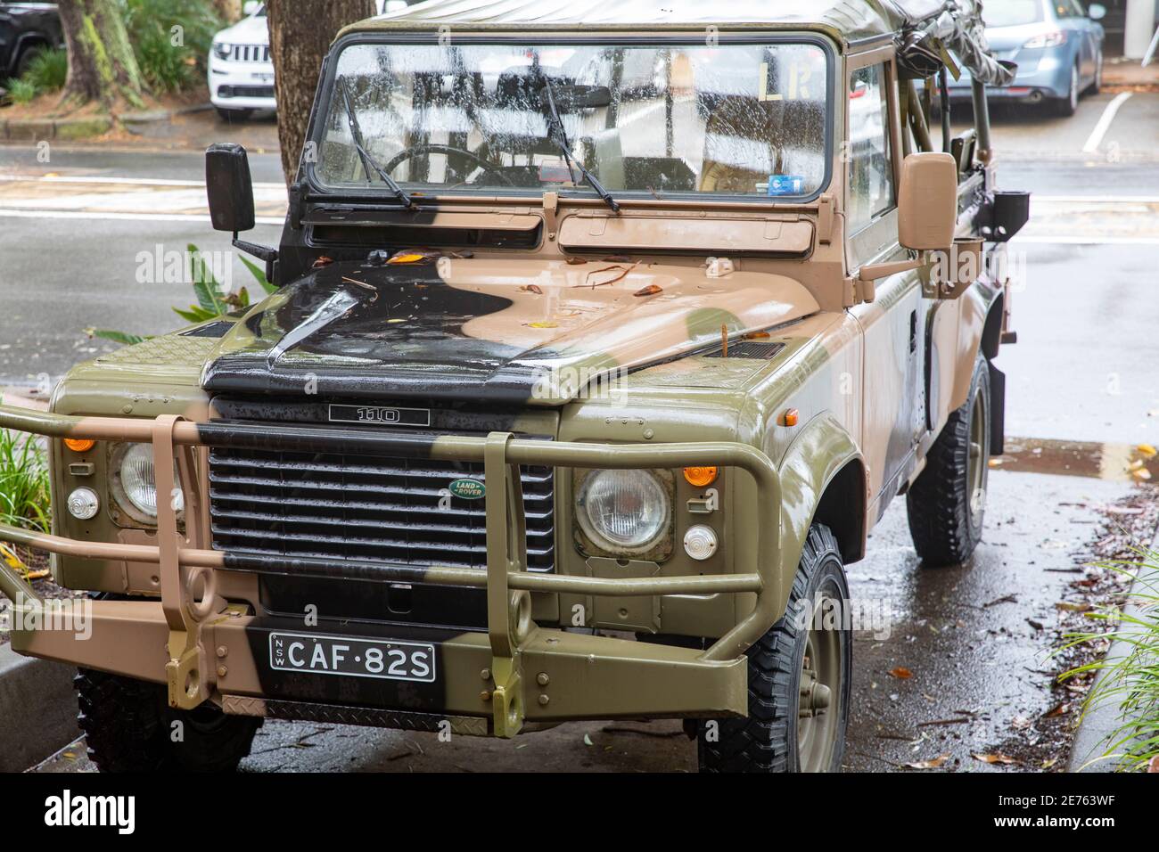 Classic Land Rover Defender 110 in army camouflage colours parked in Sydney,NSW,Australia Stock Photo