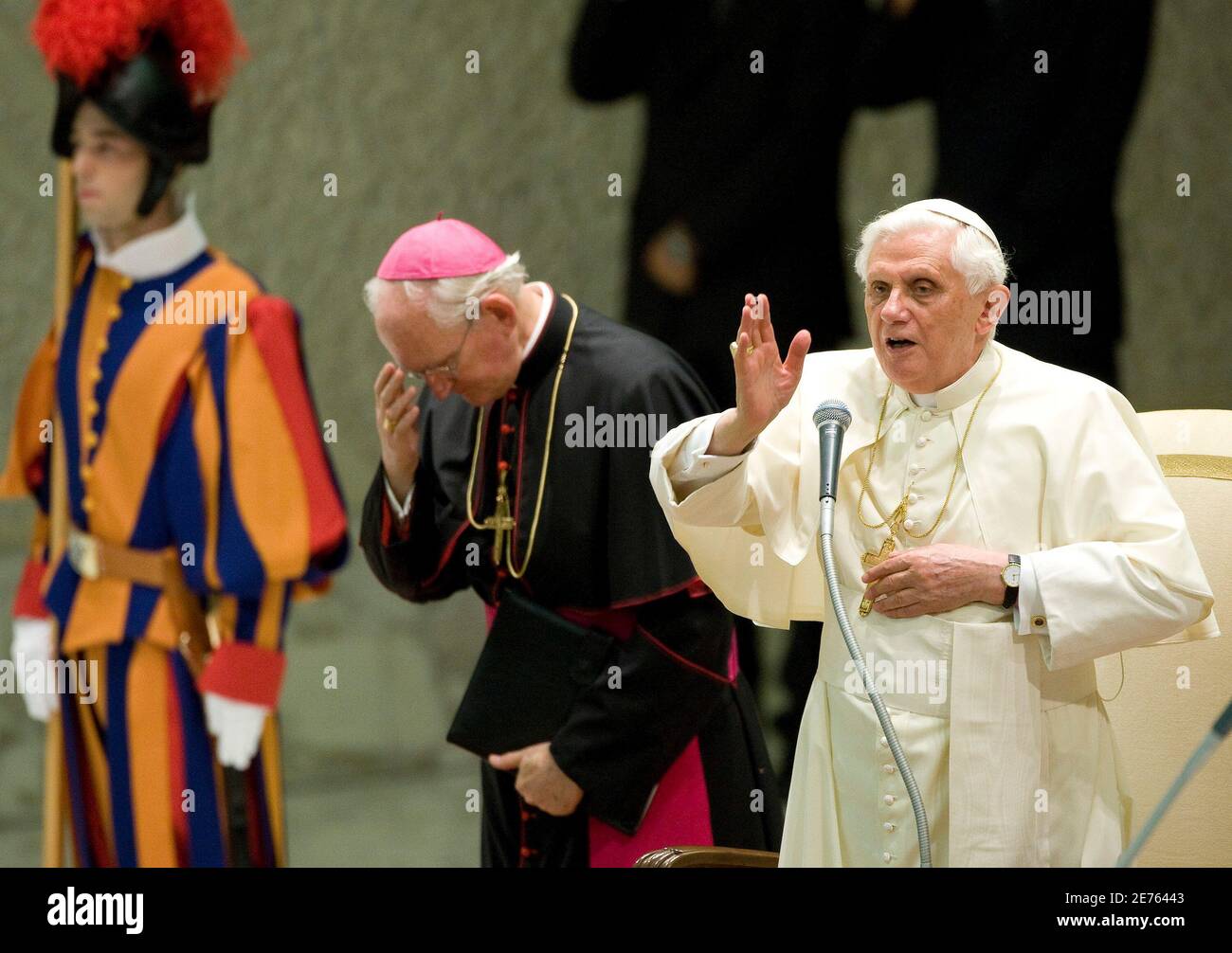 Pope Benedict XVI makes a blessing next to Archbishop James Harvey (C) and  a Swiss Guard during his weekly general audience at the Vatican August 27,  2008. Pope Benedict on Wednesday condemned