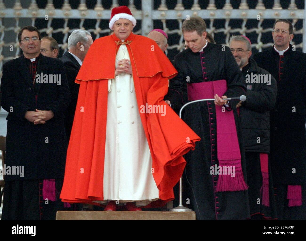 Pope Benedict XVI, wearing the white fur-trimmed red bonnet reserved to  Popes and called camauro, arrives to celebrate his general audience in St.  Peter's square at the Vatican December 21, 2005 Stock