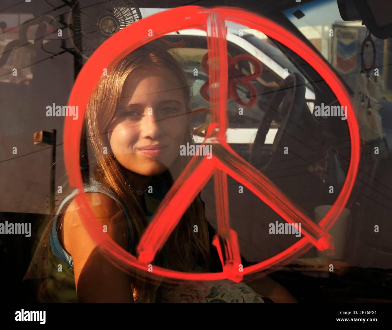 Jaycee Kane Is Framed By A Peace Symbol Painted On Her Van In Reference To Hurricane Rita As She Takes A Break From Traffic In East Houston September 22 05 Lane And